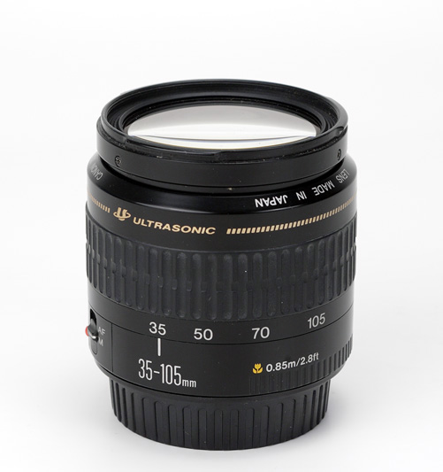 Canon EF 35-105mm F4.5-5.6 USM Side View showing zoom scale, minimum focusing distance and model name inscription