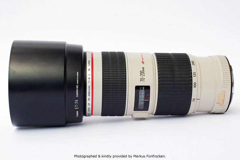 Canon EF 70-200mm F4.0L IS USM Side View with lens hood ET-74 showing model name inscriptions, focus scale, wide zoom and focus rings